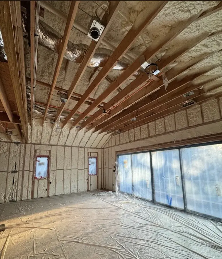 Interior walls and ceiling insulated with spray foam during new construction in Champion Heights